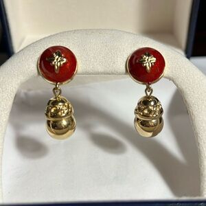 Vintage Avon gold tone dangly pierced earrings with red enamel detailing.